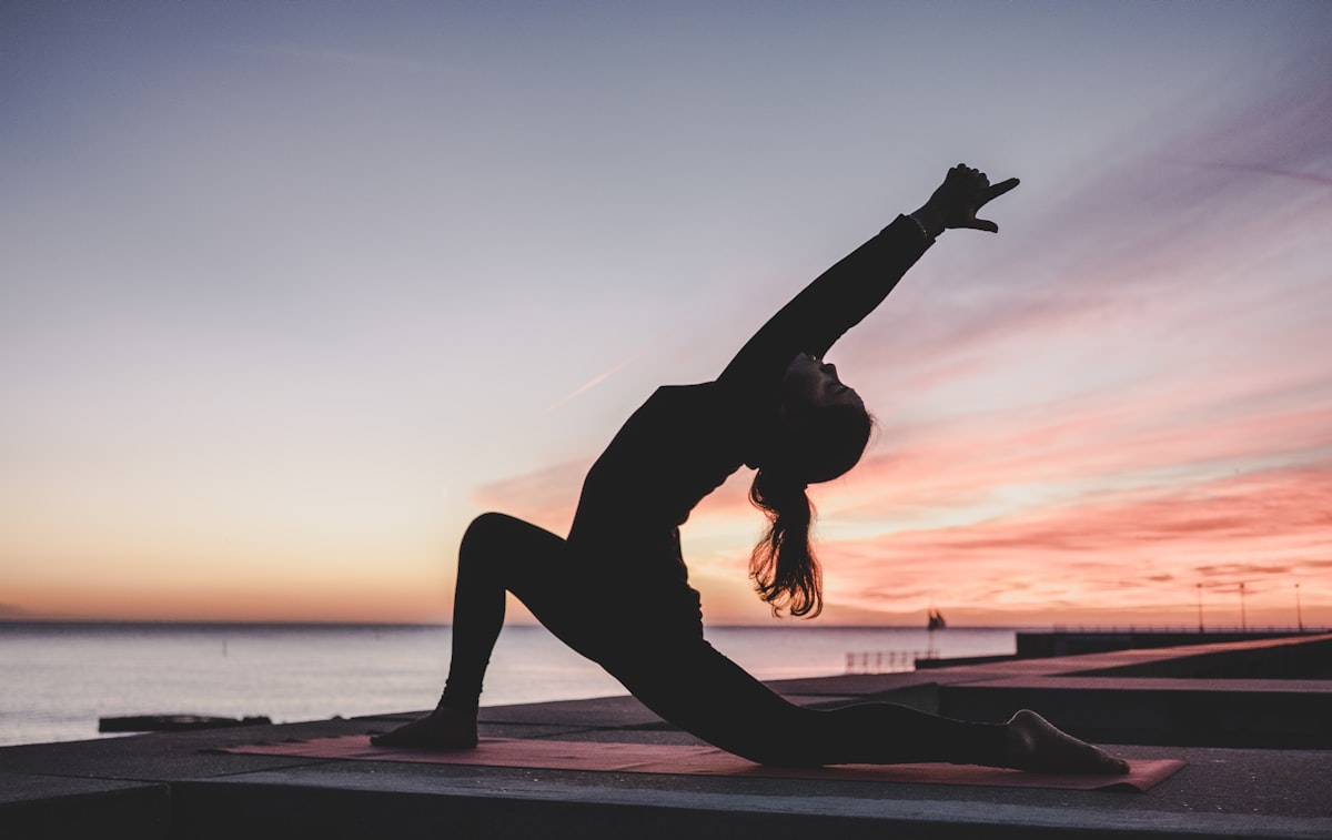 Yoga practice at sunset by the Adriatic coast